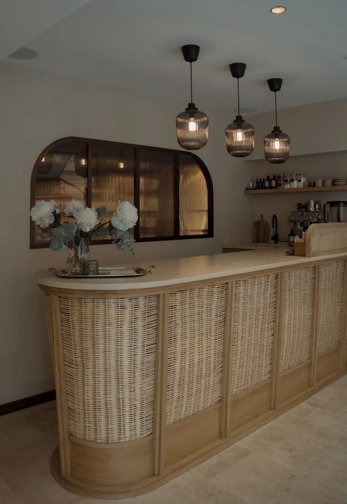 The rattan coffee bar at For/Me with peonies and fluted glass