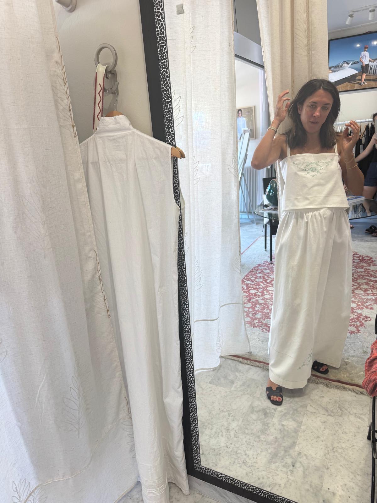 The finished set worn in the atelier mirror, with the pieces on a hanger alongside